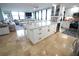 Kitchen island with seating, modern stainless steel appliances, and white cabinets is the heart of the home at 6415 Midnight Pass Rd # 904, Sarasota, FL 34242