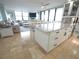 Open concept kitchen features island with marble countertop and seating, perfect for entertaining with a seamless view of the living room at 6415 Midnight Pass Rd # 904, Sarasota, FL 34242
