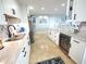 Kitchen featuring travertine floors, white cabinets, granite countertops, stainless steel appliances and a wine fridge at 6415 Midnight Pass Rd # 904, Sarasota, FL 34242