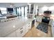 Spacious kitchen featuring modern white cabinets, stainless steel appliances, travertine floors, and a stylish tile backsplash at 6415 Midnight Pass Rd # 904, Sarasota, FL 34242