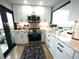 Modern kitchen featuring white cabinets, stainless appliances, marble countertops, and a view from a balcony at 6415 Midnight Pass Rd # 904, Sarasota, FL 34242