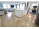 Kitchen featuring white cabinets, travertine floors, granite countertops, stainless steel appliances and opens to living room at 6415 Midnight Pass Rd # 904, Sarasota, FL 34242