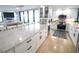 Well-appointed kitchen with white cabinets, stainless appliances, marble countertops, island, and open floorplan at 6415 Midnight Pass Rd # 904, Sarasota, FL 34242