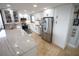 Well-appointed kitchen with stainless steel appliances, sleek cabinetry, and an expansive island at 6415 Midnight Pass Rd # 904, Sarasota, FL 34242
