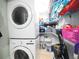 Efficient laundry closet with stacked washer and dryer and ample storage shelves for supplies at 6415 Midnight Pass Rd # 904, Sarasota, FL 34242