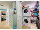 Functional laundry area featuring a stacked washer and dryer, plus storage shelving for convenience at 6415 Midnight Pass Rd # 904, Sarasota, FL 34242