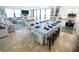 Open living space with dining table and blue accents, complemented by a modern kitchen with stainless steel appliances at 6415 Midnight Pass Rd # 904, Sarasota, FL 34242