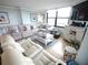 Relaxing living room with comfortable seating, stylish decor, and plenty of natural light from the large windows at 6415 Midnight Pass Rd # 904, Sarasota, FL 34242
