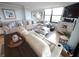 Comfortable living room with a large sectional, recliner, and coastal decor, flooded with natural light at 6415 Midnight Pass Rd # 904, Sarasota, FL 34242
