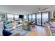 Spacious living room with large windows offering panoramic views of the ocean and the outdoor terrace at 6415 Midnight Pass Rd # 904, Sarasota, FL 34242