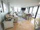 Bright living room featuring a large sectional couch, decorative rug, and sliding glass doors to balcony at 6415 Midnight Pass Rd # 904, Sarasota, FL 34242