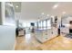 Open-concept living space showcasing the kitchen, island, and living room with natural light and coastal decor at 6415 Midnight Pass Rd # 904, Sarasota, FL 34242