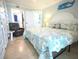 Comfortable bedroom with a decorative blue accents, a bed with themed pillows and a cozy sitting area at 6415 Midnight Pass Rd # 904, Sarasota, FL 34242