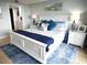 Well-lit main bedroom featuring a king bed, ensuite bathroom, and coastal-inspired decor at 6415 Midnight Pass Rd # 904, Sarasota, FL 34242