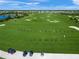 Aerial view of the golf course with golfers and sand traps at 7108 Callander Cv, Lakewood Ranch, FL 34202