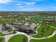 Aerial view of clubhouse surrounded by golf course and waterways, showcasing the expansive community at 7108 Callander Cv, Lakewood Ranch, FL 34202