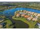Aerial view of the home on the water, surrounded by mature trees and manicured lawns at 7108 Callander Cv, Lakewood Ranch, FL 34202