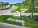 The Lodge community entrance sign with meticulously maintained landscaping and palm trees at 7108 Callander Cv, Lakewood Ranch, FL 34202