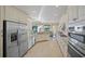 Modern kitchen featuring stainless steel appliances, granite countertops, and ample cabinet space overlooking the backyard at 7108 Callander Cv, Lakewood Ranch, FL 34202