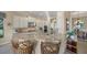 Gourmet kitchen featuring granite countertops, stainless steel appliances, and bar seating overlooking water at 7108 Callander Cv, Lakewood Ranch, FL 34202
