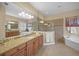 Luxurious main bathroom with dual vanities, soaking tub, and glass shower at 7108 Callander Cv, Lakewood Ranch, FL 34202