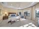Spacious main bedroom with tray ceilings, natural light, and views of the backyard at 7108 Callander Cv, Lakewood Ranch, FL 34202