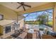 Inviting outdoor kitchen and seating area with a screened lanai, hot tub, and pool at 7108 Callander Cv, Lakewood Ranch, FL 34202