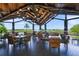 Outdoor seating area overlooking lush golf course with tables and chairs at 7108 Callander Cv, Lakewood Ranch, FL 34202