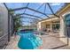 Relax and enjoy the pool and spa with a screened lanai and a beautiful lake view at 7108 Callander Cv, Lakewood Ranch, FL 34202