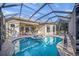 The covered back patio features a sparkling swimming pool, hot tub, and cozy seating area, perfect for outdoor enjoyment at 7108 Callander Cv, Lakewood Ranch, FL 34202