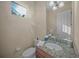 Neat powder room with granite countertop vanity, under mount sink, and accent lighting at 7108 Callander Cv, Lakewood Ranch, FL 34202