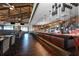 Upscale restaurant interior with bar, dining tables, and well-lit kitchen area at 7108 Callander Cv, Lakewood Ranch, FL 34202