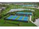 Aerial view of tennis courts with a beautiful residential community at 7108 Callander Cv, Lakewood Ranch, FL 34202