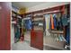 Spacious walk-in closet with custom built-in shelves and drawers for ample storage and organization at 7108 Callander Cv, Lakewood Ranch, FL 34202
