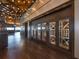 Elegant wine cellar with glass-enclosed storage in a warmly lit space at 7108 Callander Cv, Lakewood Ranch, FL 34202