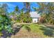 Wide backyard with mature trees and lush landscaping provides privacy and tranquility at 7821 Geneva Ln # 11, Sarasota, FL 34243