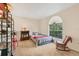 Cozy bedroom with a large window, neutral carpet, and a rocking chair at 7821 Geneva Ln # 11, Sarasota, FL 34243