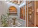 Charming courtyard with stone accents, arched window, and tranquil water feature offers a peaceful retreat at 7821 Geneva Ln # 11, Sarasota, FL 34243