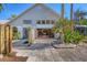 Back exterior of house features large windows and sliding doors with access to an enclosed lanai at 7821 Geneva Ln # 11, Sarasota, FL 34243