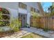 Inviting front entrance with a garden, pathway, and a charming wooden fence at 7821 Geneva Ln # 11, Sarasota, FL 34243