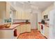 Kitchen featuring tiled floor, a window over sink and bright cabinets at 7821 Geneva Ln # 11, Sarasota, FL 34243