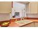 Kitchen sink with view to the lanai and bright countertops at 7821 Geneva Ln # 11, Sarasota, FL 34243