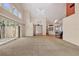 Spacious living room with high ceilings, carpet flooring, and sliding glass doors to outdoor space at 7821 Geneva Ln # 11, Sarasota, FL 34243