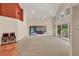 Bright living room boasts high ceilings, carpet flooring, and sliding glass doors to a patio with a hot tub at 7821 Geneva Ln # 11, Sarasota, FL 34243