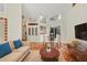 Bright open-concept living room is adjacent to dining area and features tile flooring and comfortable furnishings at 7821 Geneva Ln # 11, Sarasota, FL 34243