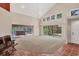 Bright living room with high ceilings, tiled floors, and sliding doors to the outdoor area at 7821 Geneva Ln # 11, Sarasota, FL 34243