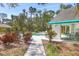 Community pool area with covered pavilion, lush landscaping, and inviting lounge chairs at 7821 Geneva Ln # 11, Sarasota, FL 34243