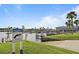 Community boat ramp surrounded by lush landscaping and a manatee warning sign at 788 Imperial Dr, North Port, FL 34287