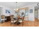 Elegant dining area featuring wood floors, a chandelier, and a built-in display cabinet at 788 Imperial Dr, North Port, FL 34287