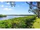 Scenic water view with lush greenery, showcasing tranquil waterfront living at 788 Imperial Dr, North Port, FL 34287